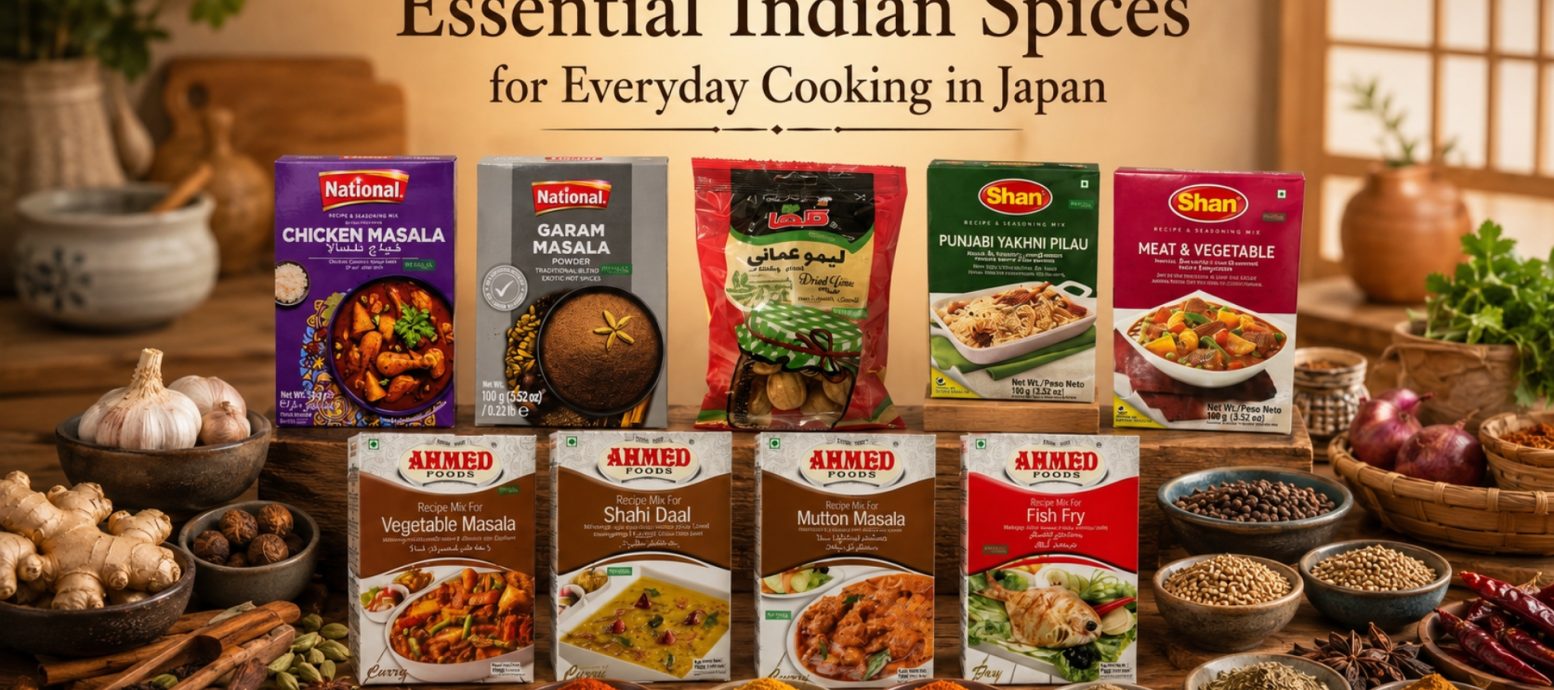 Essential Indian spices and various National, Shan, and Ahmed Foods recipe mix packets arranged on a wooden table