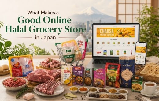 A laptop and smartphone showing an online store, with a shopping cart, assorted meat products, spices, and grains arranged on a table against a backdrop of a city and mountain view.